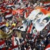 Chính phủ từ chức, hàng nghìn người biểu tình ủng hộ Tổng thống Bashar al-Assad. (Ảnh: AFP/TTXVN)