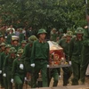 Lễ truy điệu an táng hài cốt liệt sỹ quân tình nguyện Việt Nam hy sinh tại Campuchia tại nghĩa trang tỉnh Bình Phước. (Ảnh: V.Việt-H.Dụng/Vietnam+)