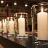 Mười hai ngọn nến được thắp sáng để tưởng niệm 10 nạn nhân. (Nguồn: Getty Images)
