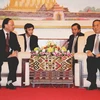 Chủ tịch Chummaly Saynhasone tiếp Ủy viên Bộ Chính trị, Tô Huy Rứa. (Ảnh: Hoàng Chương/Vietnam+)