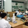 Hoạt động nghiệp vụ tại Sở Giao dịch Vietcombank (Hà Nội). (Ảnh: Huy Hùng/TTXVN) 