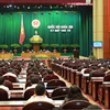 Quốc hội biểu quyết thông qua Nghị quyết về phân bổ ngân sách trung ương năm 2013. (Ảnh: Nhan Sáng/TTXVN)