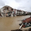 Quốc tế cần đoàn kết để đẩy lùi thảm họa thiên tai. (Ảnh: AFP/TTXVN)