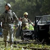 Binh sỹ Mỹ tại hiện trường một vụ đánh bom ở Afghanistan. (Nguồn: AFP/TTXVN) 