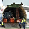 Các nhân viên sân bay đang bốc dỡ máy nhiệt điện chạy bằng khí đốt Antonov 124. (Nguồn: PV/Vietnam+)