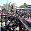 Những người ủng hộ Tổng thống Bashar al-Assad ở Sweida, phía nam thủ đô Damascus hồi tháng Mười. (Nguồn: AFP/TTXVN)
