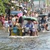 Cảnh ngập lụt tại một đường phố ở Calumpit, phía Bắc thủ đô Manila. (Nguồn: AFP/TTXVN)