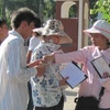 Các đối tượng chèo kéo thí sinh mua tăm ngay cổng chính của Học viện An ninh nhân dân. (Ảnh: Phạm Mai/Vietnam+).