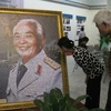 Người dân xúc động chiêm ngưỡng bức ảnh có một không hai về Đại tướng Võ Nguyên Giáp. (Ảnh: Thiên Linh/ Vietnam+)