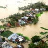 Khu dân cư phía đông huyện Tuy Phước, tỉnh Bình Định ngập chìm trong nước lũ do cơn bão số 11 gây ra. (Ảnh: Viết Ý/TTXVN) 