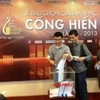Các nhà báo khu vực phía Bắc bỏ phiếu bầu chọn giải Cống hiến lần thứ 8 tại Hà Nội. (Ảnh: Cẩm Thơ/ Vietnam+)