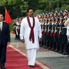 Chủ tịch Nguyễn Minh Triết và Tổng thống Sri Lanka Mahinda Rajapaksa duyệt đội danh dự. (Ảnh: Nguyễn Khang/TTXVN)