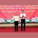 Phó Chủ tịch UBND tỉnh Kiên Giang Nguyễn Lưu Trung trao giải Nhất cho tác giả đạt giải viết về chính luận Bảo vệ nền tảng tư tưởng của Đảng. (Ảnh: Lê Sen/TTXVN)