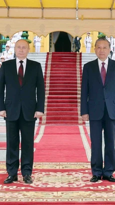 Chủ tịch nước Tô Lâm và Tổng thống Liên bang Nga Vladimir Putin trên bục danh dự, nghe quân nhạc cử Quốc thiều hai nước. (Ảnh: Nhan Sáng/TTXVN)