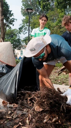 Cùng chung tay dọn dẹp, vệ sinh môi trường, khắc phục hậu quả bão số 3. (Ảnh: Minh Quyết/TTXVN)