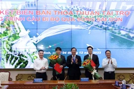 Chủ tịch UBND Thành phố Hồ Chí Minh Phan Văn Mãi tặng hoa chúc mừng. (Ảnh: Tiến Lực/TTXVN)
