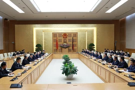 Thủ tướng Phạm Minh Chính tiếp Chủ tịch Chính hiệp Trung Quốc Vương Hộ Ninh. (Ảnh: Dương Giang/TTXVN)