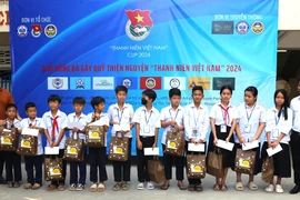 Trao quà và học bổng cho con em người gốc Việt tại Trường Tiểu học Hữu nghị Khmer-Việt Nam Tân Tiến. (Ảnh: Hoàng Minh/TTXVN)