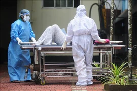 Nhân viên y tế chuyển bệnh nhân có triệu chứng nhiễm virus Nipah tới bệnh viện ở Kozikode, bang Kerala, Ấn Độ. (Ảnh: AFP/TTXVN)