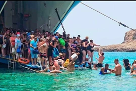 Du khách phải lội nước vào đảo. (Nguồn: ekathimerini.com)