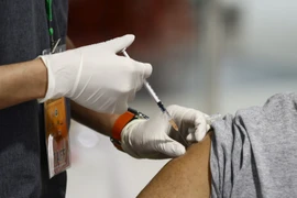Người dân tiêm vaccine ngừa COVID-19. (Ảnh: AFP/TTXVN)