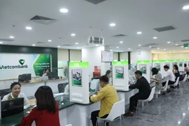 Các đại biểu Quốc hội nhất trí chủ trương bổ sung vốn điều lệ cho Vietcombank. (Ảnh: Vietnam+)