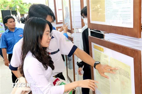 Học sinh Trường THPT huyện Bắc Bình (Bình Thuận) xem triển lãm tài liệu cổ khẳng định chủ quyền Hoàng Sa, Trường Sa của Việt Nam. (Ảnh: Nguyễn Thanh/TTXVN)