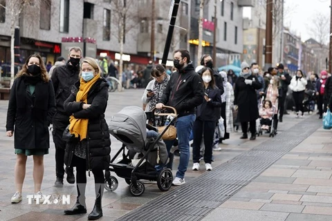 Người dân xếp hàng chờ lấy mẫu xét nghiệm COVID-19 tại London, Anh. (Ảnh: AFP/TTXVN)