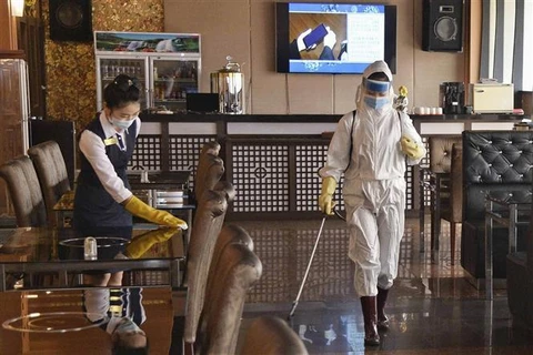 Nhân viên phun khử trùng tại một nhà hàng ở Bình Nhưỡng, Triều Tiên để phòng chống dịch COVID-19, ngày 29/3/2022. Ảnh: Kyodo/TTXVN
