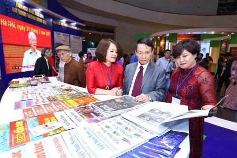 Tổng giám đốc TTXVN Nguyễn Đức Lợi xem gian trưng bày các ấn phẩm của TTXVN tại Hội báo toàn quốc 2019. (Ảnh: Minh Quyết/TTXVN)