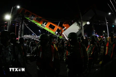 Lực lượng cứu hộ làm nhiệm vụ tại hiện trường vụ sập đường sắt trên cao ở Mexico City, Mexico ngày 3/5/2021. (Ảnh: THX/TTXVN)