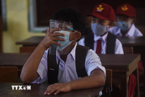 Học sinh đeo khẩu trang phòng lây nhiễm COVID-19 trong ngày đầu tiên quay lại trường học sau nhiều tháng do dịch bệnh COVID-19 tại Tây Java, Indonesia, ngày 6/9/2021. (Ảnh: THX/TTXVN)
