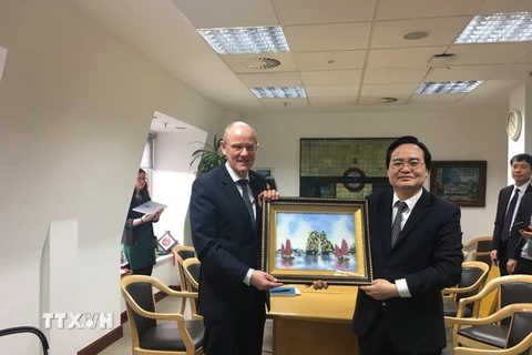 Bộ trưởng Giáo dục và Đào tạo Phùng Xuân Nhạ tặng quà lưu niệm cho Quốc vụ khanh Bộ Giáo dục Anh Nick Gibb. (Ảnh: Tuấn Anh/TTXVN)