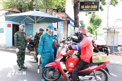 Lực lượng dân quân tham gia kiểm soát tại các chốt chặn phòng dịch trong thời gian Thành phố Hồ Chí Minh giãn cách xã hội. (Ảnh: Xuân Khu/TTXVN)