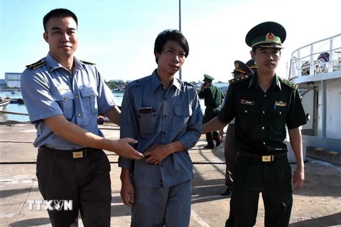 Lực lượng chức năng đưa thuyền viên Nguyễn Văn Dũng lên xe cứu thương đến bệnh viện Bà Rịa tiếp tục điều trị. (Ảnh: Huỳnh Ngọc Sơn/TTXVN)
