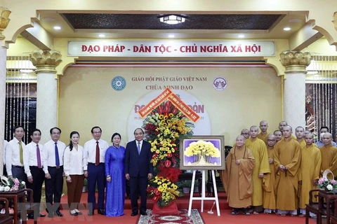Chủ tịch nước Nguyễn Xuân Phúc thực hiện nghi thức tắm Phật khi tới thăm chùa Minh Đạo. (Ảnh: Thống Nhất/TTXVN) 