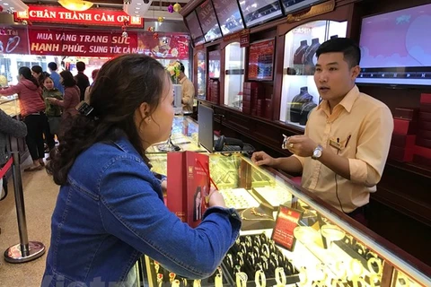 Khách hàng giao dịch vàng tại thị trường Hà Nội. (Ảnh: Đức Duy/Vietnam+)