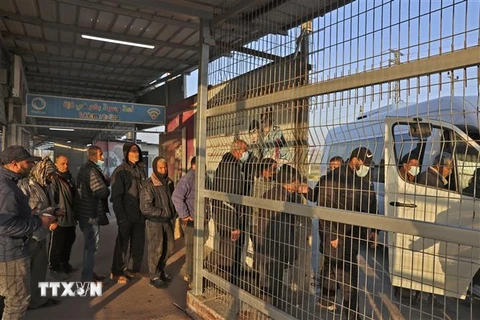 Người lao động Palestine đi qua cửa khẩu Erez ở Beit Hanun, phía bắc Dải Gaza, để tới làm việc tại Israel ngày 23/2/2022. (Ảnh: AFP/TTXVN) 
