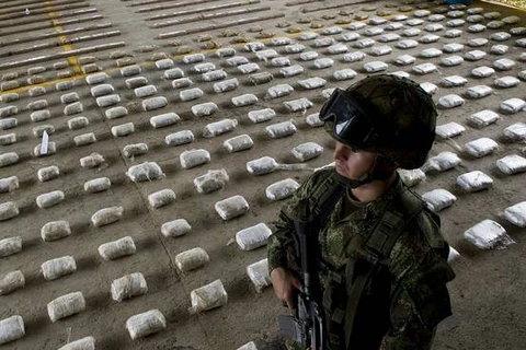 Một binh sỹ quân đội Colombia đứng cạnh số cocaine bị thu giữ. (Ảnh: AFP)