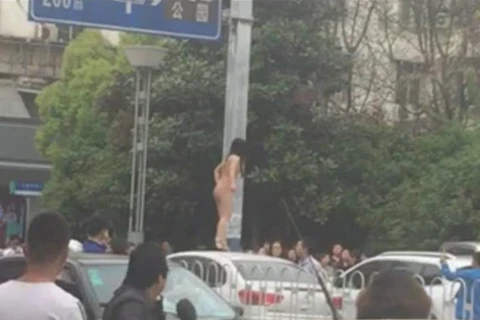 Cô gái khỏa thân nhảy múa trên nóc ôtô. (Nguồn: shanghaiist.com)