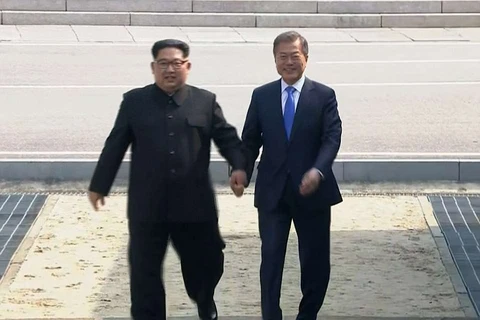 Hai nhà lãnh đạo dắt tay nhau tiến vào cuộc gặp thượng đỉnh được cả thế giới mong đợi. (Nguồn: AP)