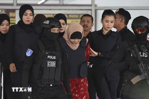 Cảnh sát áp giải nghi phạm Siti Aisyah (giữa) tới tòa án ở ngoại ô Kuala Lumpur, Malaysia ngày 14/12. (Ảnh: AFP/TTXVN)