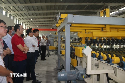 Các đại biểu tham quan dây chuyển sản xuất tại Nhà máy kính nổi siêu trắng Phú Mỹ tại Bà Rịa-Vũng Tàu. (Ảnh: Hoàng Nhị/TTXVN)