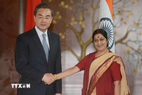 Ngoại trưởng Trung Quốc Vương Nghị (trái) bắt tay người đồng cấp Ấn Độ Sushma Swaraj. (Nguồn: AFP/TTXVN)