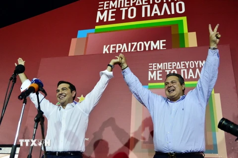 Lãnh đạo Đảng Syriza Alexis Tsipras (trái) và lãnh đạo Đảng ANEL Panos Kamenos chia sẻ niềm vui chiến thắng. (Ảnh: AFP/TTXVN)