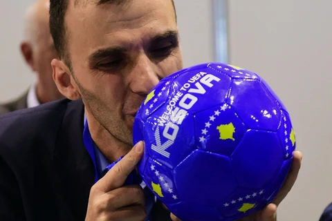Một thành viên phái đoàn của Kosovo ăn mừng sau kết quả bỏ phiếu của UEFA tại Budapest. (Nguồn: AFP)