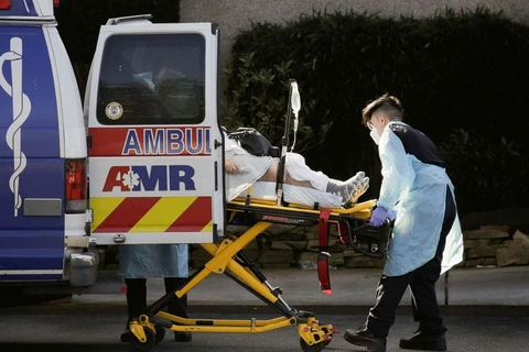 Nhân viên y tế vận chuyển người nhiễm COVID-19. (Ảnh: Getty Images)