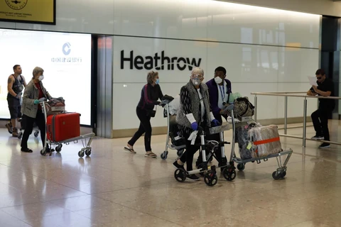 Hành khách tại sân bay quốc tế Heathrow ở London, Anh ngày 22/5/2020. (Ảnh: AFP/TTXVN)