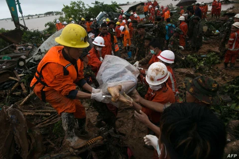Lực lượng cứu hộ đưa thi thể một người thiệt mạng do sạt sở đất tại Myanmar. (Nguồn: AFP)