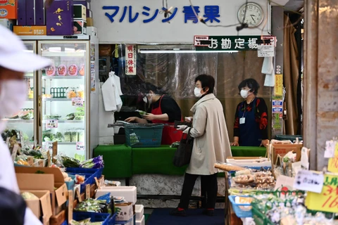 Người dân mua bán hàng hóa tại một cửa hàng ở Tokyo, Nhật Bản, ngày 21/4/2020. (Ảnh: AFP/TTXVN)